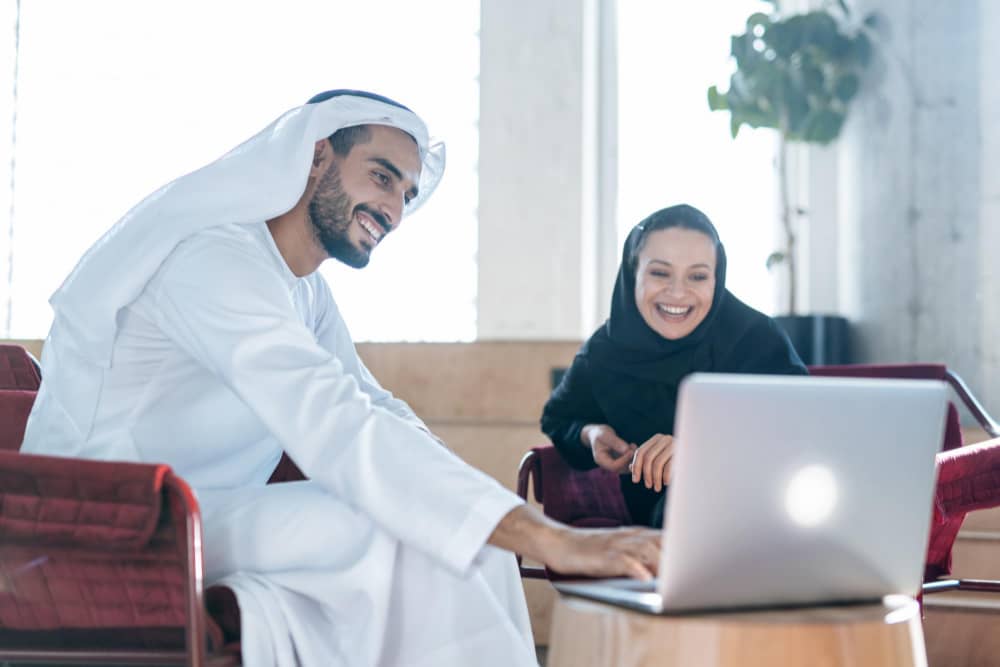 man woman with traditional emirates clothes working business office dubai