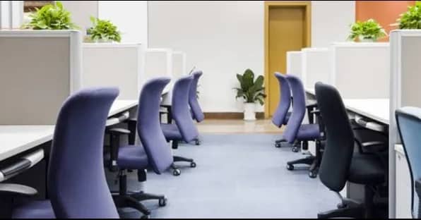 A set of cubicles with chairs inside a new office location in Dubai, by Austria BC