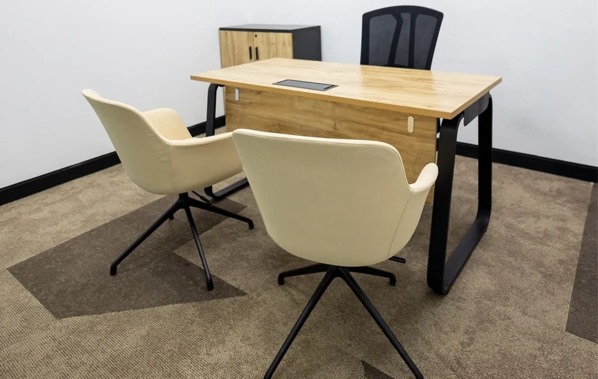 An interior of a private serviced office in Al Hudaiba with chairs and tables, by Austria BC
